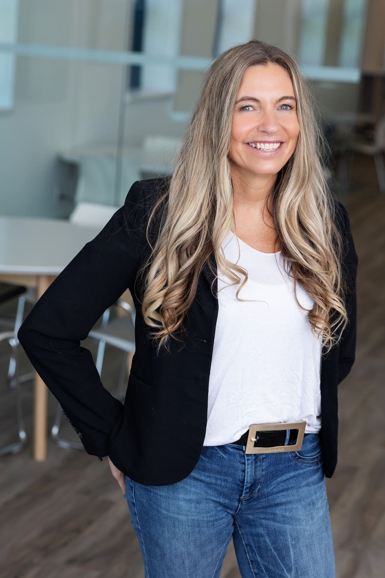 Full-length portrait of a Level Up facilitator in a blazer and jeans.